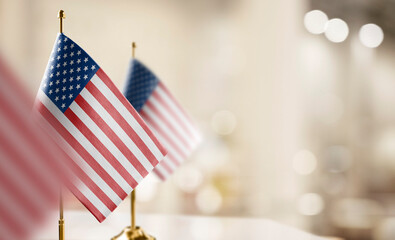 Small flags of the USA on an abstract blurry background