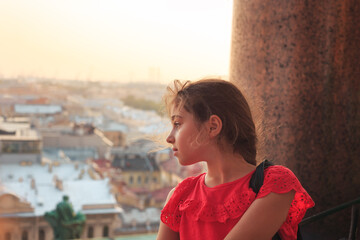 Portrait of a cute teenager girl is smiling and having fun outdoors at summer evening