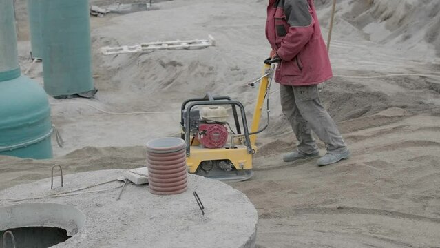 Vibratory hammer power tool on the ground at the construction work. Construction work on the plant