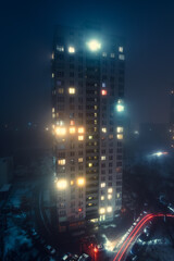 Residential building in the fog at night in Kyiv.