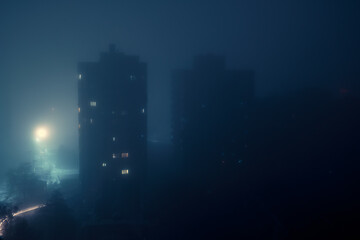 Residential building during a blackout at night in the fog. After the russian missile attacks. Kyiv, Ukraine. - 552989454