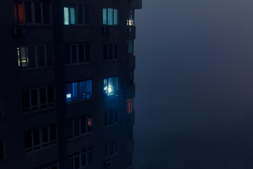 Residential building during a blackout at night in the fog. After the russian missile attacks. Kyiv, Ukraine. - 552989463