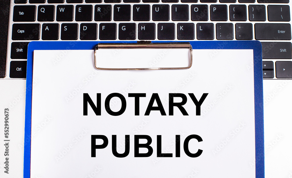 Poster a workplace with a keyboard and a tablet for papers with notary public text