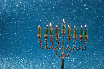 Jewish holiday Hanukkah background with menorah -traditional candelabra and candles