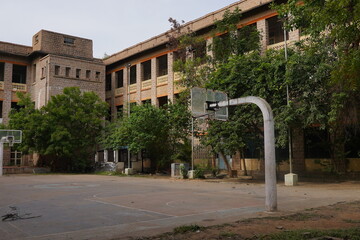 old vintage stone building with basket ball court