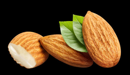 Almonds with leaves, isolated on black background