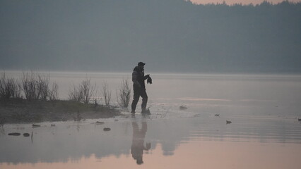 hunting by the creek in the forest. And hunting birds. Hunter hunting at sunrise