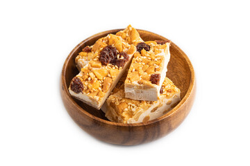 Traditional candy nougat with nuts and sesame isolated on white, side view.