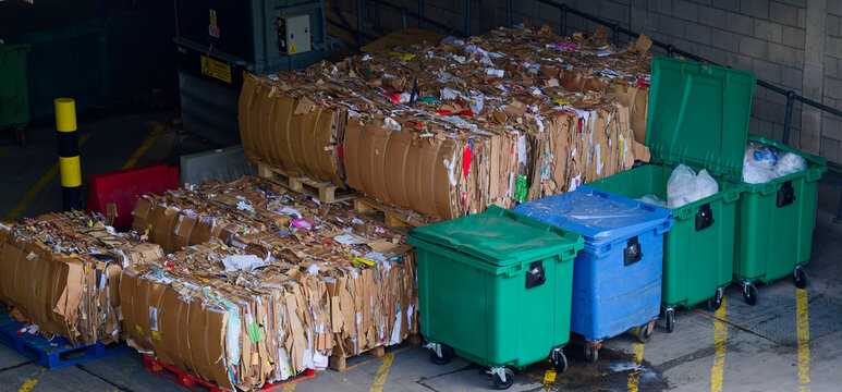 Cardboard and rubbish in waste compound for disposal at dump site
