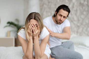 Relationship of family, problems in couple, quarrel concept. Loving caucasian man calming his...
