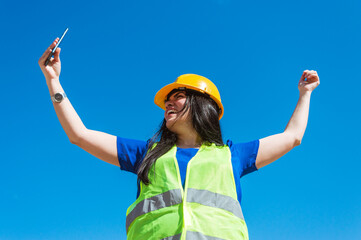 happy young female engineer is celebrating for her new contract