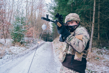 Fototapeta premium Soldier celebrates Christmas in a war zone. Christmas at war
