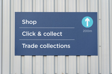 Click collect online internet shopping sign at shop car park lane 
