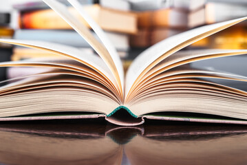 Opened book on library desk close-up