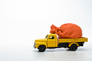 yellow pickup truck with a bag isolated on a white background. Gift concept