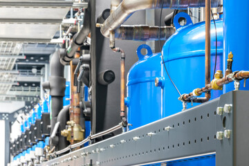 Large blue tanks in a industrial city water treatment boiler room. Special equipment, technology,...