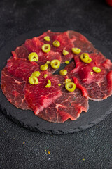 carpaccio antipasti appetizer raw meat beef thin slices fresh healthy meal food snack on the table copy space food background rustic top view