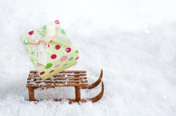 box of gifts on a sled in the snow