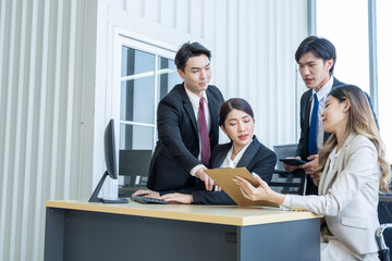 A group of young Asian businessmen Talking and planning work happily and have fun. at the company's office