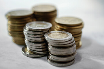 5 columns of Argentine coins on the table.