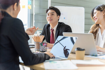 A group of young Asian businessmen Talking and planning work happily and have fun. at the company's office
