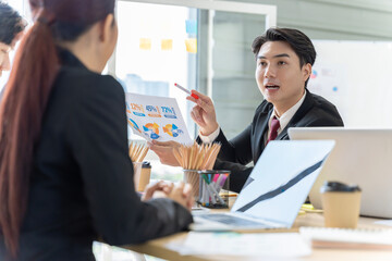 A group of young Asian businessmen Talking and planning work happily and have fun. at the company's office