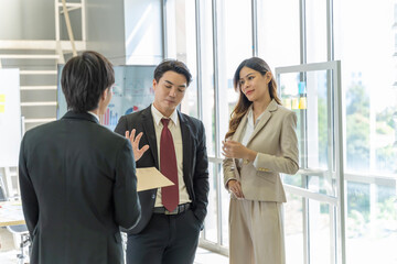 A group of young Asian businessmen Talking and planning work happily and have fun. at the company's office