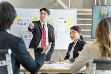 A group of young Asian businessmen Talking and planning work happily and have fun. at the company's office