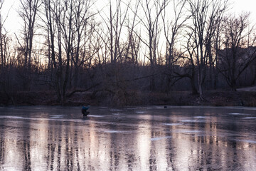 winter sport, winter fishing outside on the ice on the river or lake