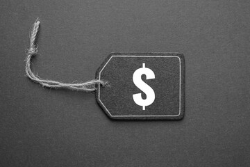 black price tag with dollar sign on the black background, black mockup