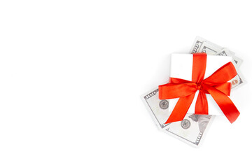 Gift box and dollars on a white background isolated, flat lay.