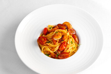 pasta with shrimps and tomatoes on a white background