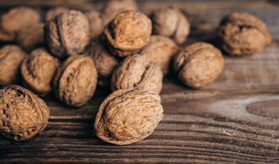 Close-up, whole walnuts on a wooden background, rustic style.
