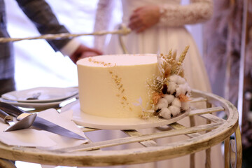 During the wedding ceremony, the newlyweds cut the wedding cake.