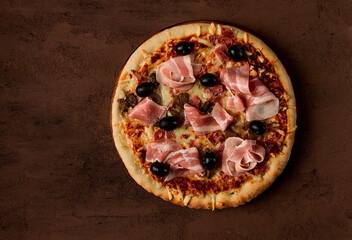 Pizza with prosciutto and mushrooms, bacon, olives, homemade, top view, no people,