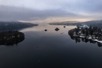 Lake Windermere,  Lake District in England in winter with snow on the ground. Aerial drone above view.