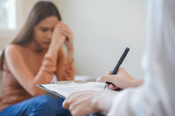 Psychology, depression. Sad, suffering asian young woman, girl consulting with psychologist,...
