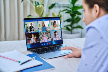 Video conference, teen girl looking at laptop screen with group of students