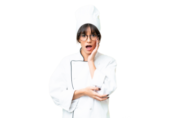 Young caucasian chef  woman over isolated chroma key background surprised and shocked while looking right