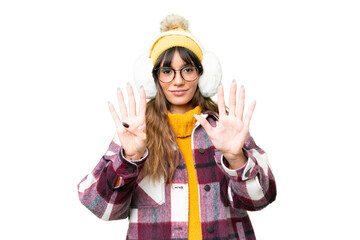 Young caucasian woman wearing winter muffs over isolated chroma key background counting nine with...