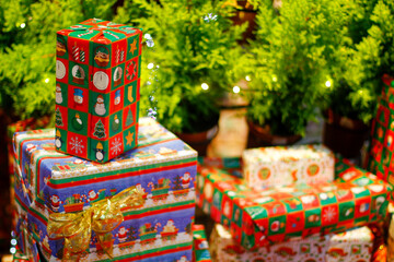 Fototapeta na wymiar Christmas gifts boxes under tree, Christmas secenery 