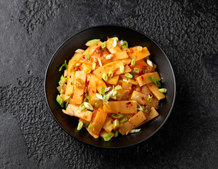 Spicy bamboo shoot salad in black bowl. Asian food