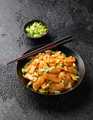 Spicy bamboo shoot salad in black bowl. Asian food