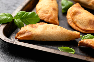 Freshly baked mini calzones filled with bolognese