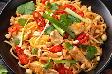 Chicken Pad Thai with eggs, bean sprouts, peanuts and spring onion