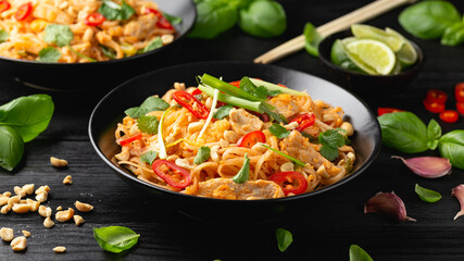 Chicken Pad Thai with eggs, bean sprouts, peanuts and spring onion