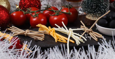 Pieces of smoked cheese in the form of a rope as an appetizer for beer on the New Year's table. Close-up