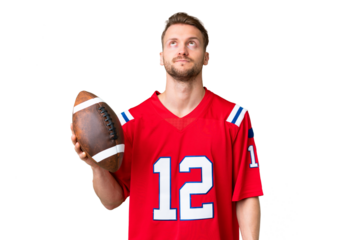 Young caucasian man playing rugby over isolated chroma key background and looking up