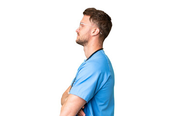Young nurse man over isolated chroma key background in lateral position