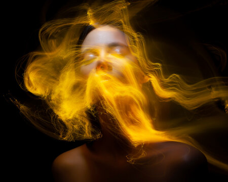 Abstract photography in the style of light painting. girl on a black background	